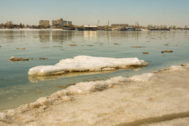 Spring melting. Ice floes float down the river in the city.