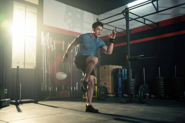 Strong young athlete fit man running in fitness gym. The man with sportswear showing his strength muscular in body. Bodybuilding exercise and sport workout training concept. Strong young athlete fit man running in fitness gym. The man with sportswear showing his strength muscular in body. Bodybuilding exercise and sport workout training concept. cardiovascular exercise stock pictures, royalty-free photos & images