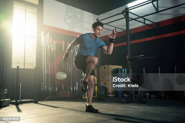 Strong Young Athlete Fit Man Running In Fitness Gym The Man With Sportswear Showing His Strength Muscular In Body Bodybuilding Exercise And Sport Workout Training Concept Stock Photo - Download Image Now