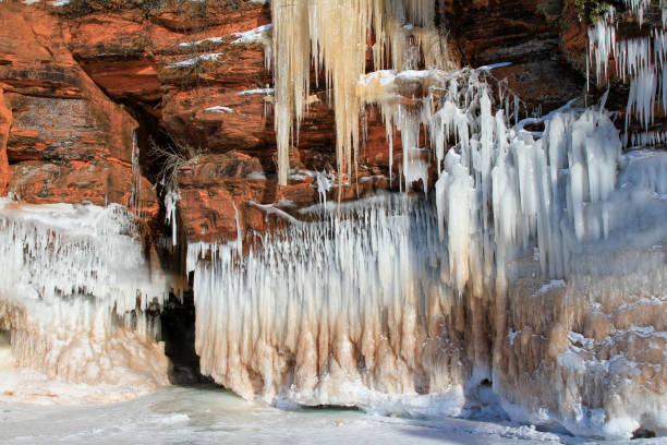 Icicles and snow on side of red cliff in Apostle Islands, Wisconsin