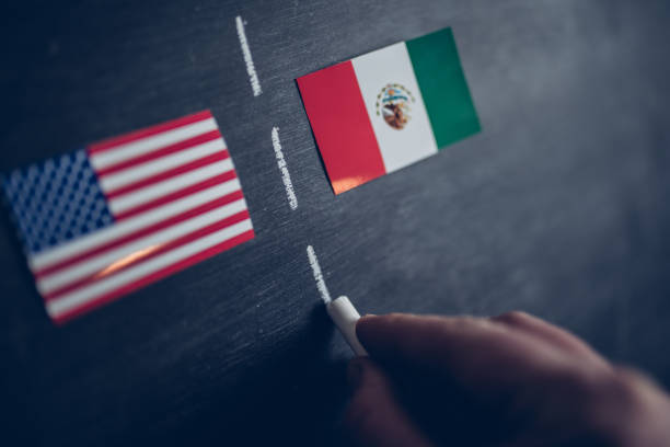 istock Hand drawing a border line between USA and Mexico 1312143891