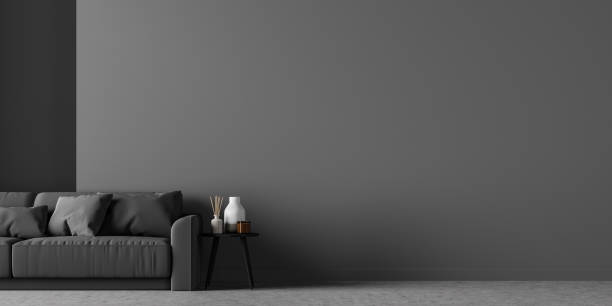 istock Living room interior with black sofa and empty grey wall 1312145182