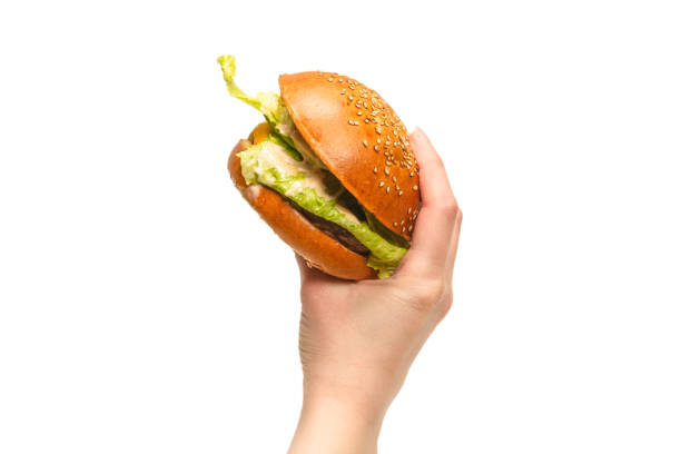 istock Hamburger in woman hands isolated on a white background. 1312146171