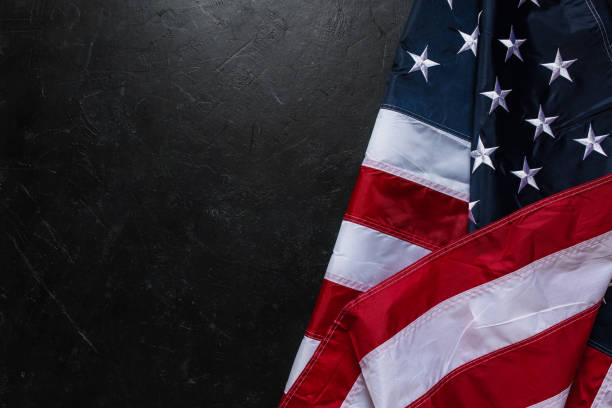 istock Flag of USA on dark background 1312146396