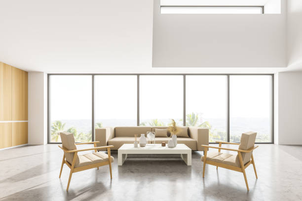 istock Light living room with sofa and armchairs near panoramic windows 1312146716