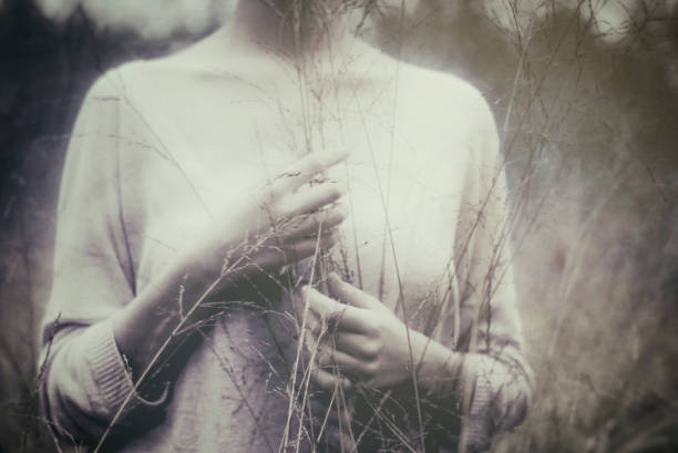 Young woman headless portrait standing in a field