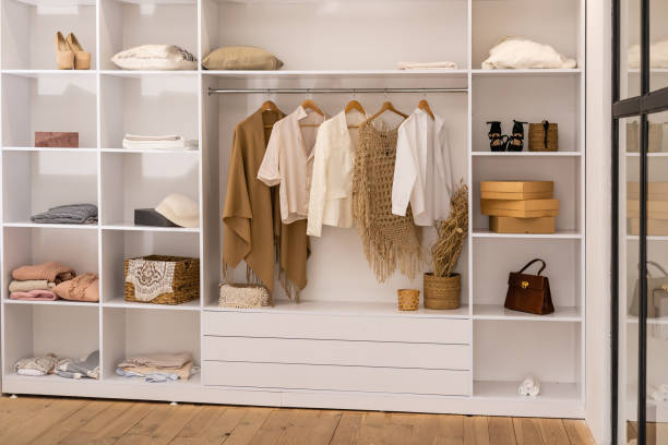 istock clothes hanging on rail in white wardrobe with boxes 1312146967