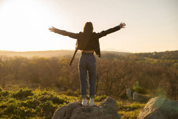 istock Woman with open arms in the field 1312147679