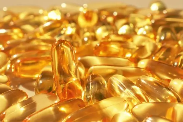 Fish oil background. Fish Oil Gelatin Capsules close-up.omega fatty acids.Natural supplements and vitamins.Healthy eating and food supplements