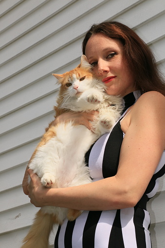 A beautiful woman holding her cat.