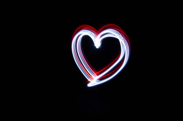 Light painting, a heart drawn with red and white light
