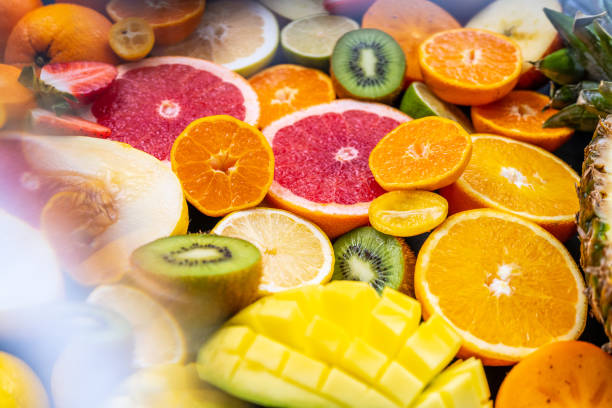 Arranged sliced tropical fruits. Miscellaneous citrus species. Raw food and healthy lifestyle concept.