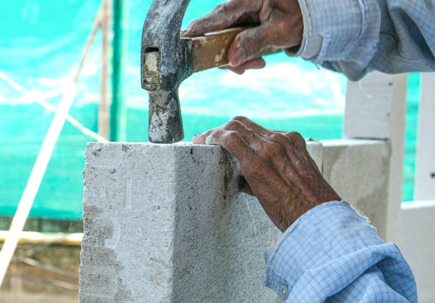 istock plaster worker use hammer hit nail iron extract white pillar structure of house for make building. 1312152266