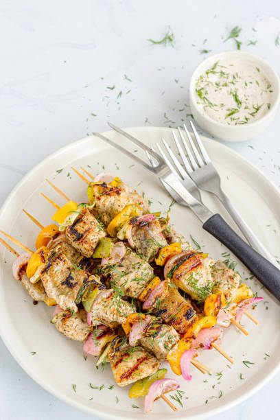 istock Grilled Fish Tikka, Fish Appetizer with Condiment Garnished with Fresh Dill on White Background 1312152331