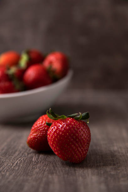 istock Strawberries in a Bowl on Rustic Wood 1312152354