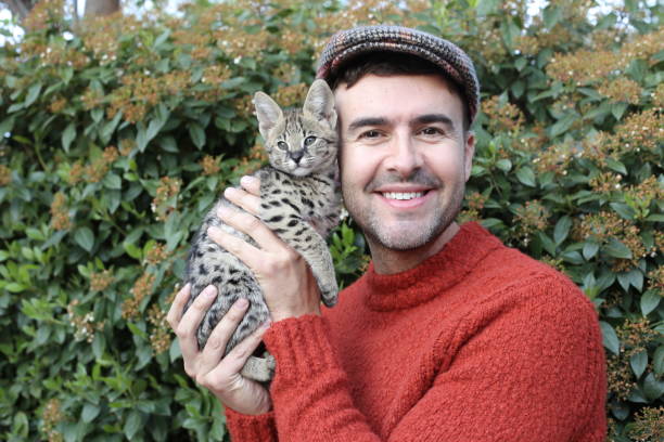 istock Man with baby cat 1312153434