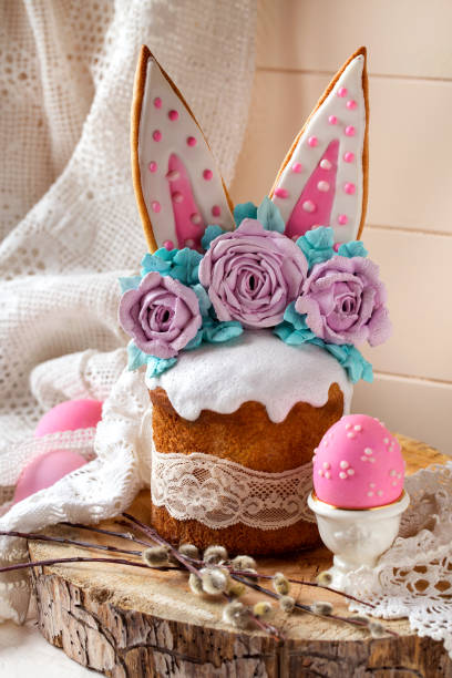 istock easter cake decorated with rabbit ears and roses meringue flowers on a light background 1312153470