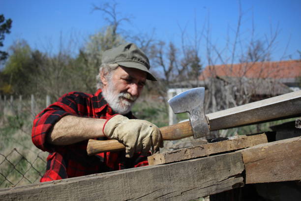 istock Older mature man working with axe and wood 1312154958
