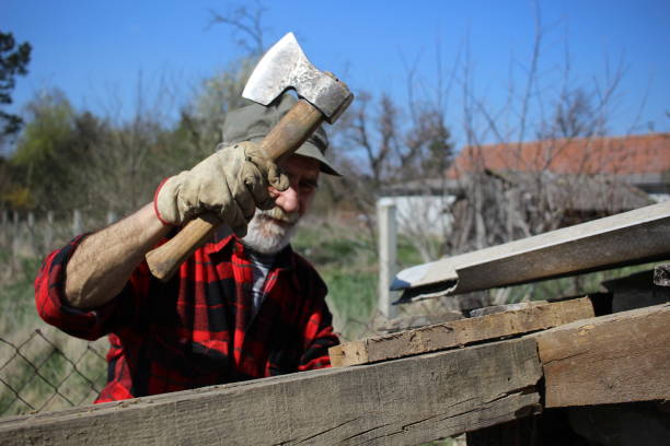 istock Older mature man working with axe and wood 1312155122