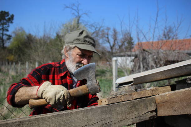 istock Older mature man working with axe and wood 1312155127