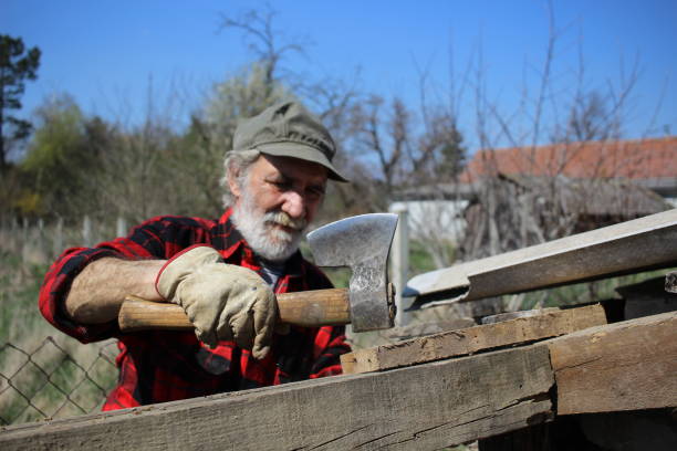 istock Older mature man working with axe and wood 1312155233