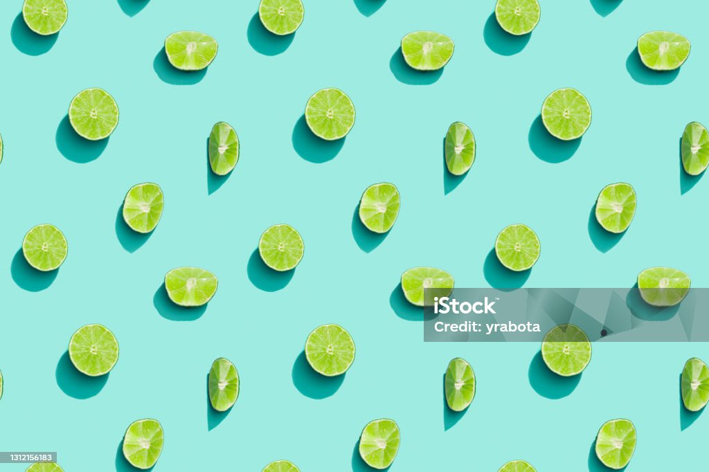 Summer fruits top view, bright juice citrus green lime on blue background. Healthy fruit food. Lime Stock Photo