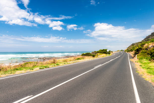 Great Ocean Road perspective A curving section of the famous Great Ocean Road in Victoria State. It is one of Australia's best loved driving routes. car point of view stock pictures, royalty-free photos & images