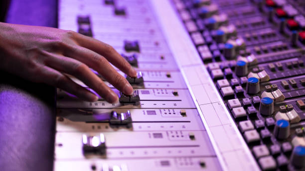 istock Hand prepared to change sound settings by moving faders on mixing control panel. 1312158990