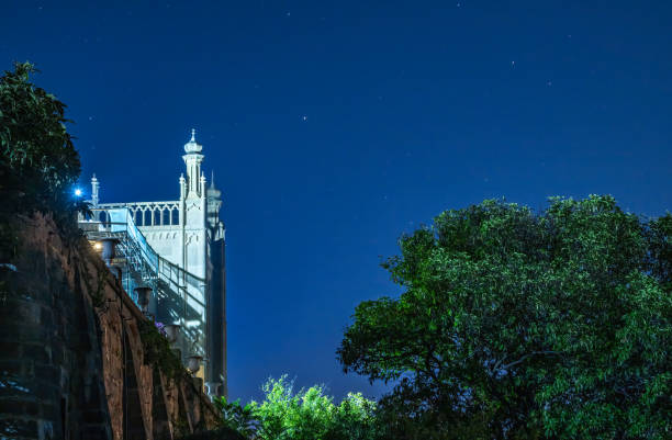 The walls and towers of the old palace at night on the background of dark sky The walls and towers of the old palace at night on the background of dark sky. Vorontsov Palace, or Alupka Palace, location place Alupka, Crimea. vorontsov palace stock pictures, royalty-free photos & images