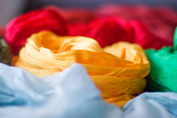 istock Bright silk scarves, yellow, blue, red, green. 1312160090