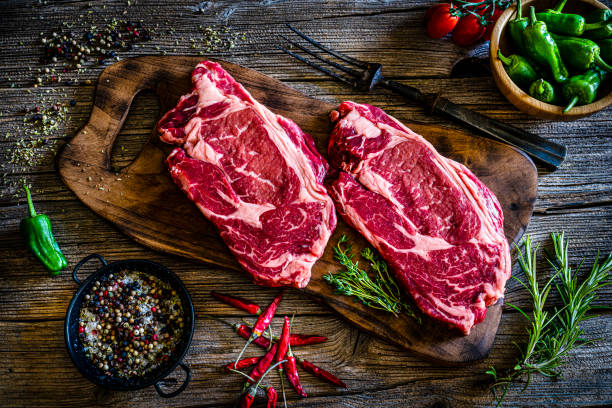 istock Juicy raw Angus fillets on cutting board. Top view 1312160689