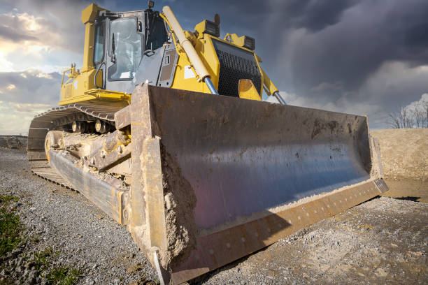 istock Track bulldozer on the construction site in dramatic light scene. Clearing, grading, excavation of trenches, and of foundations. Earth moving machinery 1312164577
