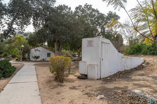 Tze'elim, Israel - March 12th, 2021: An entrance to a public bomb shelter against rocket attacks, in a kibbutz in southern Israel. The sign says \
