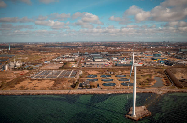 Sewage Treatment Plant and wind turbine at Avedøre Holme in Copenhagen, Denmark. Environmental conservation and preservation of clean waters resources is high priority and the Scandinavian countries are at the forefront in development of sustainable solutions for waste water treatment to secure a clean earth for future generations. Besides the waste products are recycled for energy production as green biofuel ultimately leading to decreased CO2 emission, global warming and climate change.