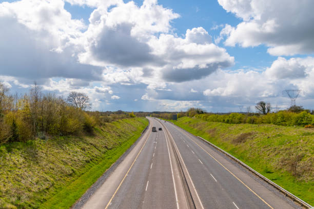 istock Countryside landscape. Empty motorway and cloudy sky . 1312170117