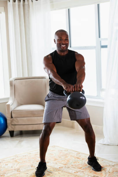 istock African-American man exercising at home with kettlebells 1312170142