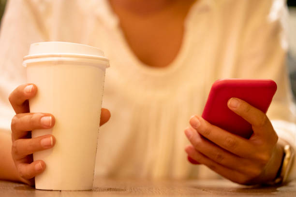 istock Woman using a Phone with coffee stock photo 1312172605