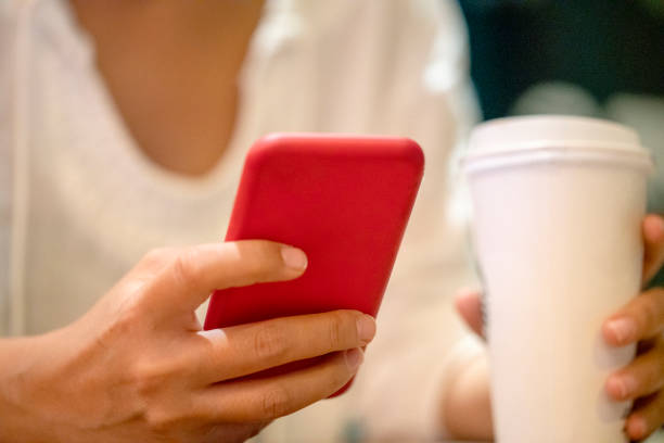 istock Woman using a Phone with coffee stock photo 1312172606