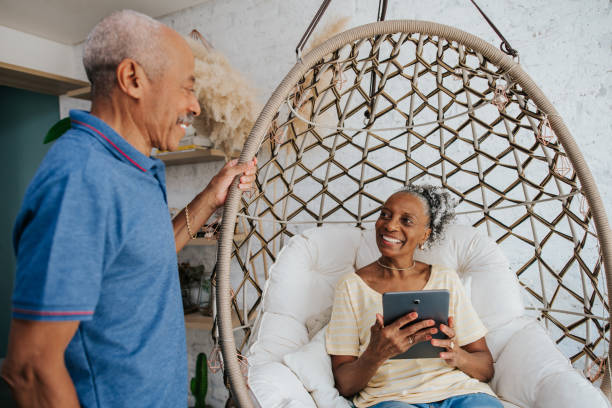 istock Senior couple at home, woman using tablet 1312173083