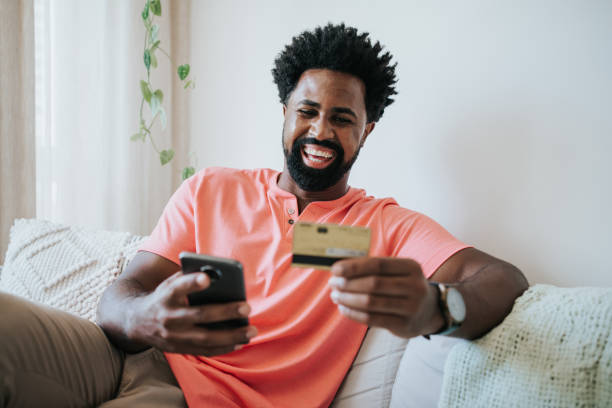 istock Man using credit card and buying online on mobile phone 1312173655