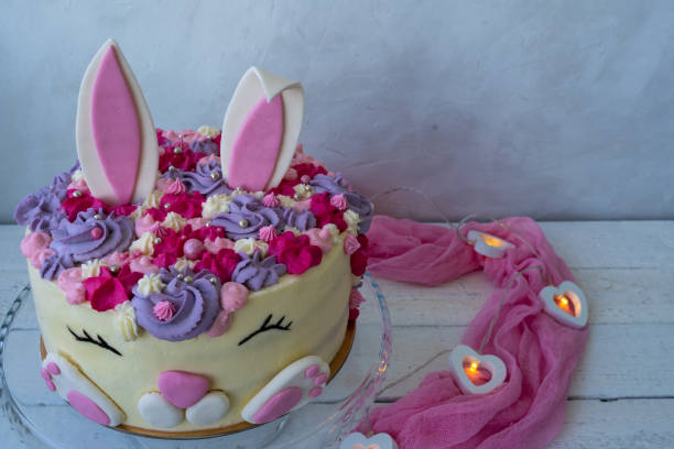 istock Unusual cake for Easter or Birthday. Ready greeting card. Cheerful bunny with a muzzle and ears. Easter cake. Children's holiday. Copy space 1312173878