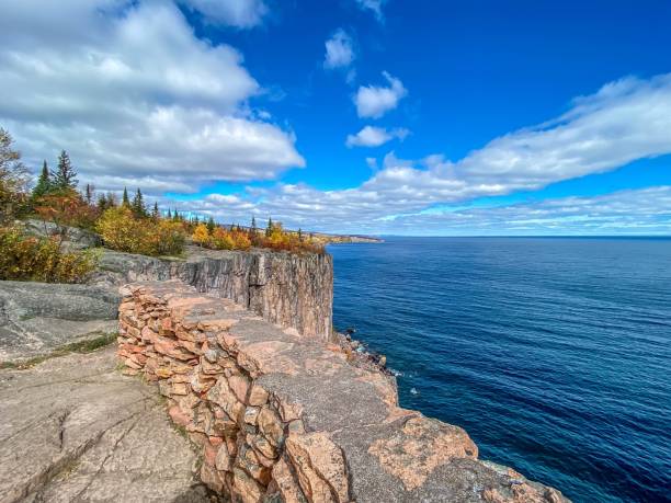 Blue Sky and Puffy White Clouds over Palisade Head in Northern Minnesota in Autumn stock photo