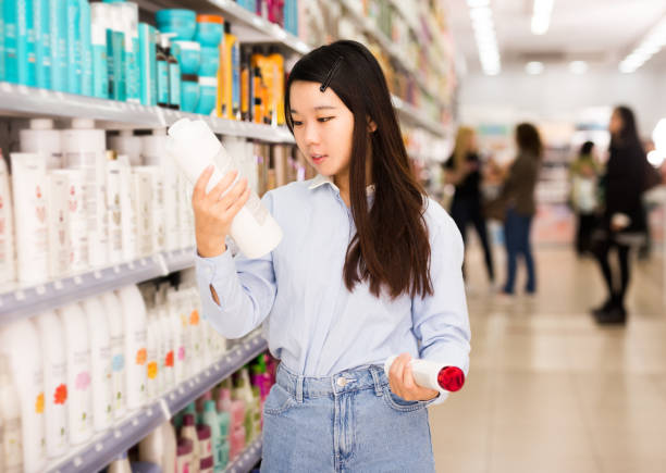 istock Asian girl customer choosing shampoo 1312174788