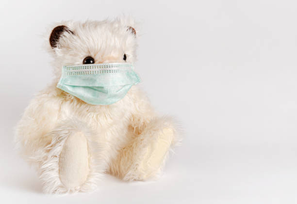 istock Teddy bear sitting in face mask 1312176476