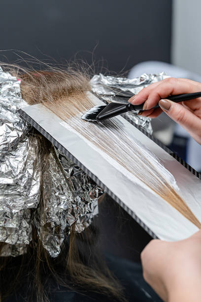 istock Hair stylist applying bleaching powder 1312177053