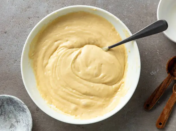 bowl of pancake dough on kitchen table, top view