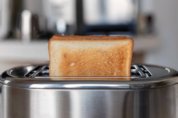 istock Fried white bread toast on the toaster, background 1312177435