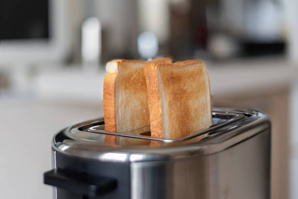 istock Two toasted slices of bread in the toaster, selective focus. 1312177612