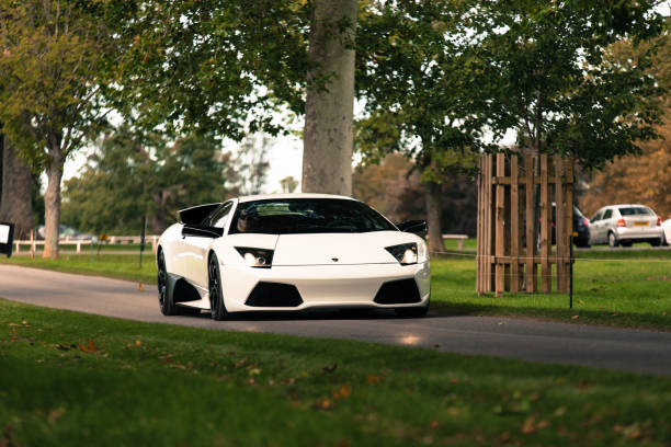 A White Lamborghini Murcielago LP640 driving down a countryside lane in Oxfordshire, England
