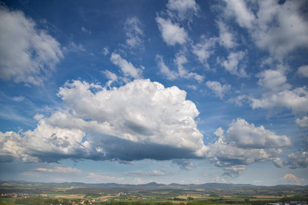 Beautiful cloudscape, white sunset clouds, natural background, green forest landscape